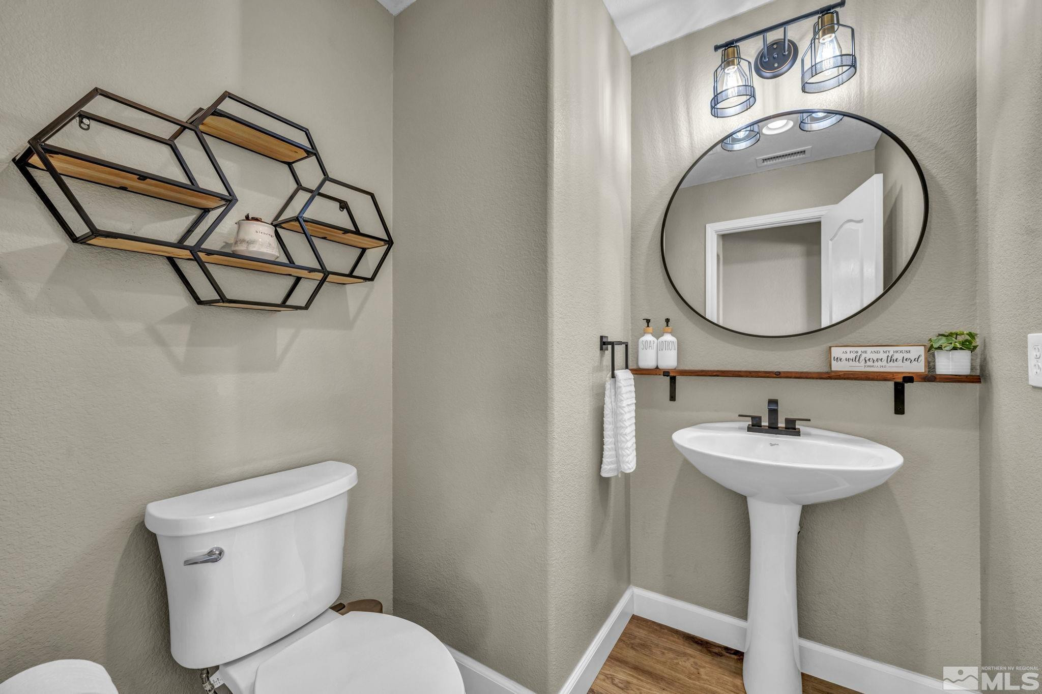 485 Sondrio Court Reno, NV 89521 - Photo 14 of 40 a bathroom with a sink mirror and toilet