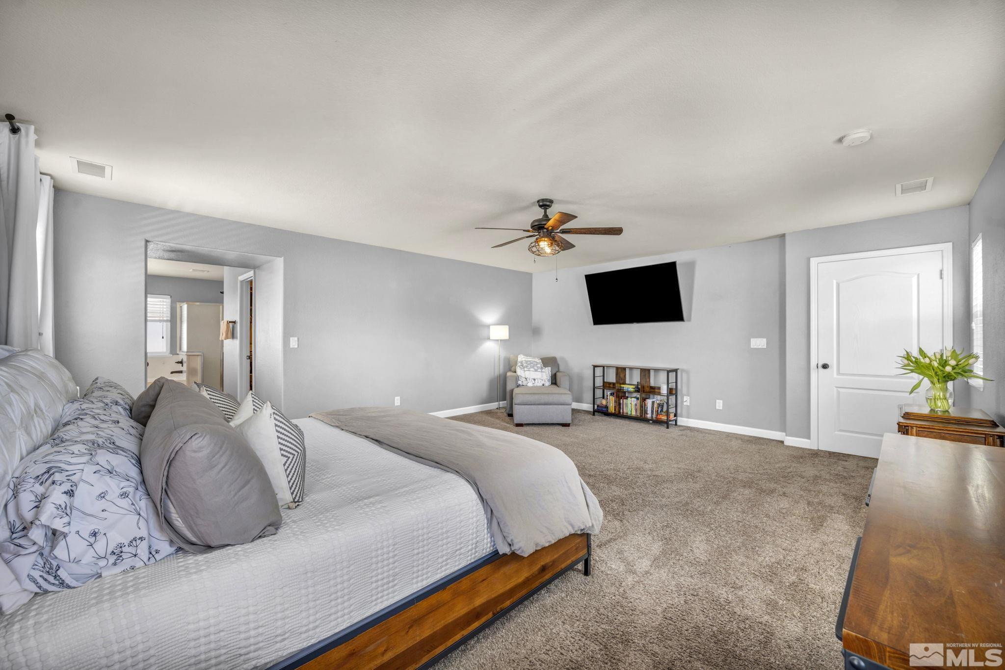 485 Sondrio Court Reno, NV 89521 - Photo 19 of 40 a bedroom with a bed and a flat screen tv