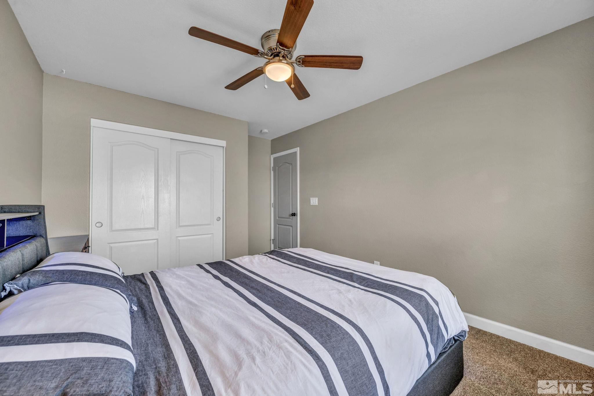 485 Sondrio Court Reno, NV 89521 - Photo 24 of 40 a bedroom with a bed and a ceiling fan