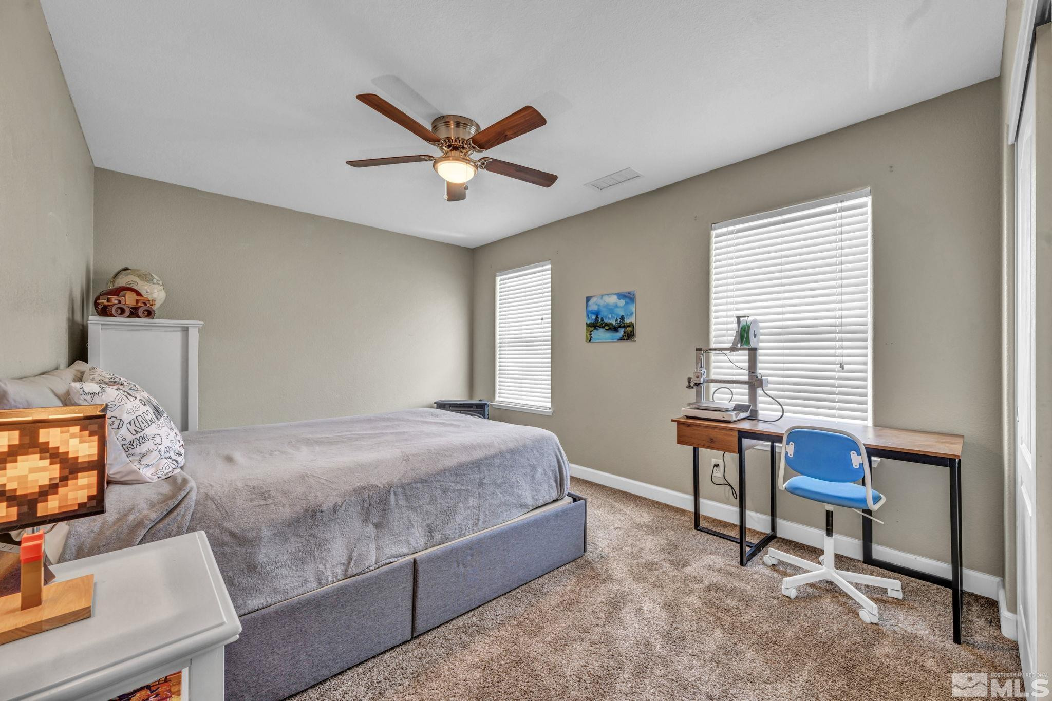 485 Sondrio Court Reno, NV 89521 - Photo 27 of 40 a bedroom with a bed and a window