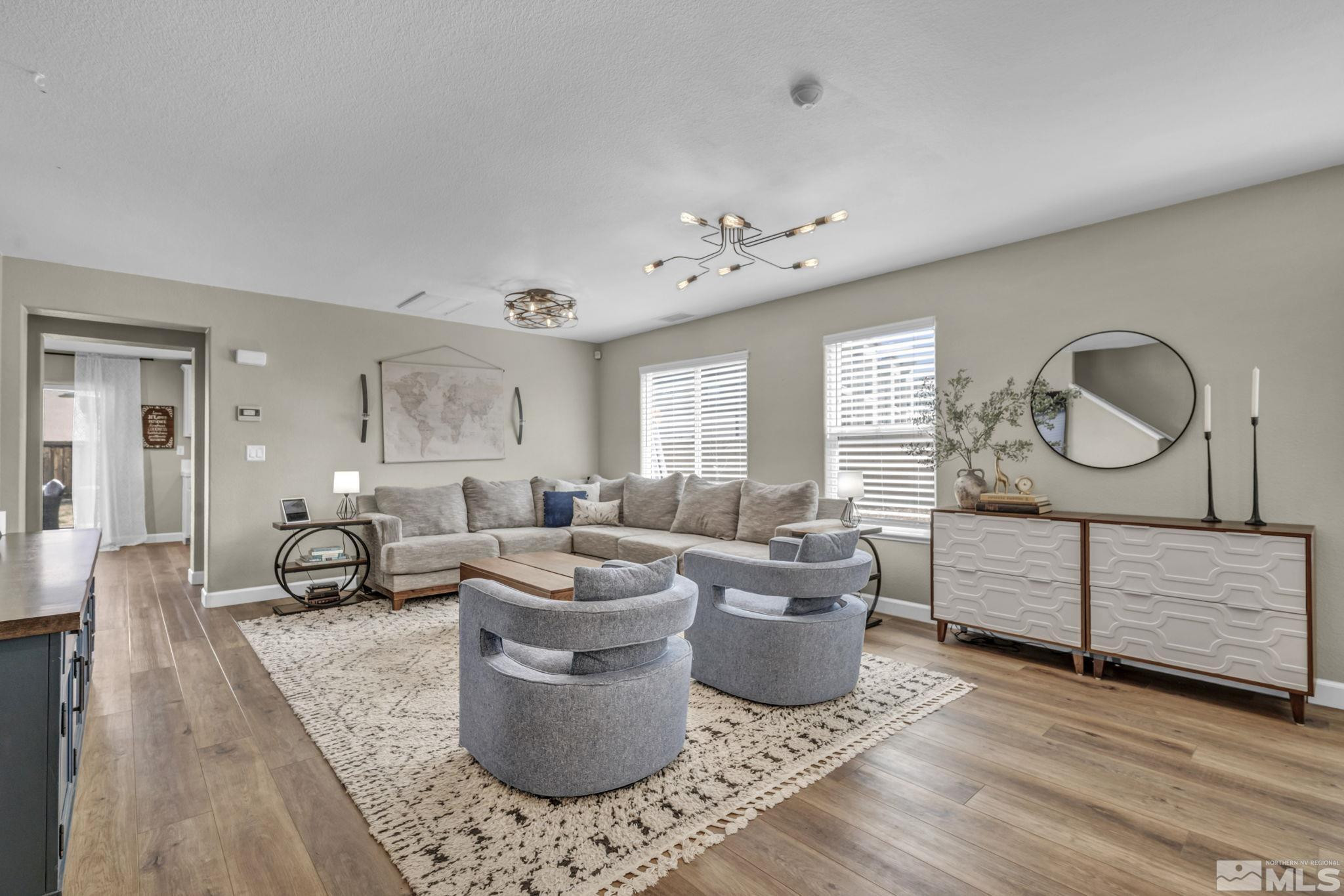 485 Sondrio Court Reno, NV 89521 - Photo 6 of 40 a living room with furniture a large window and wooden floor