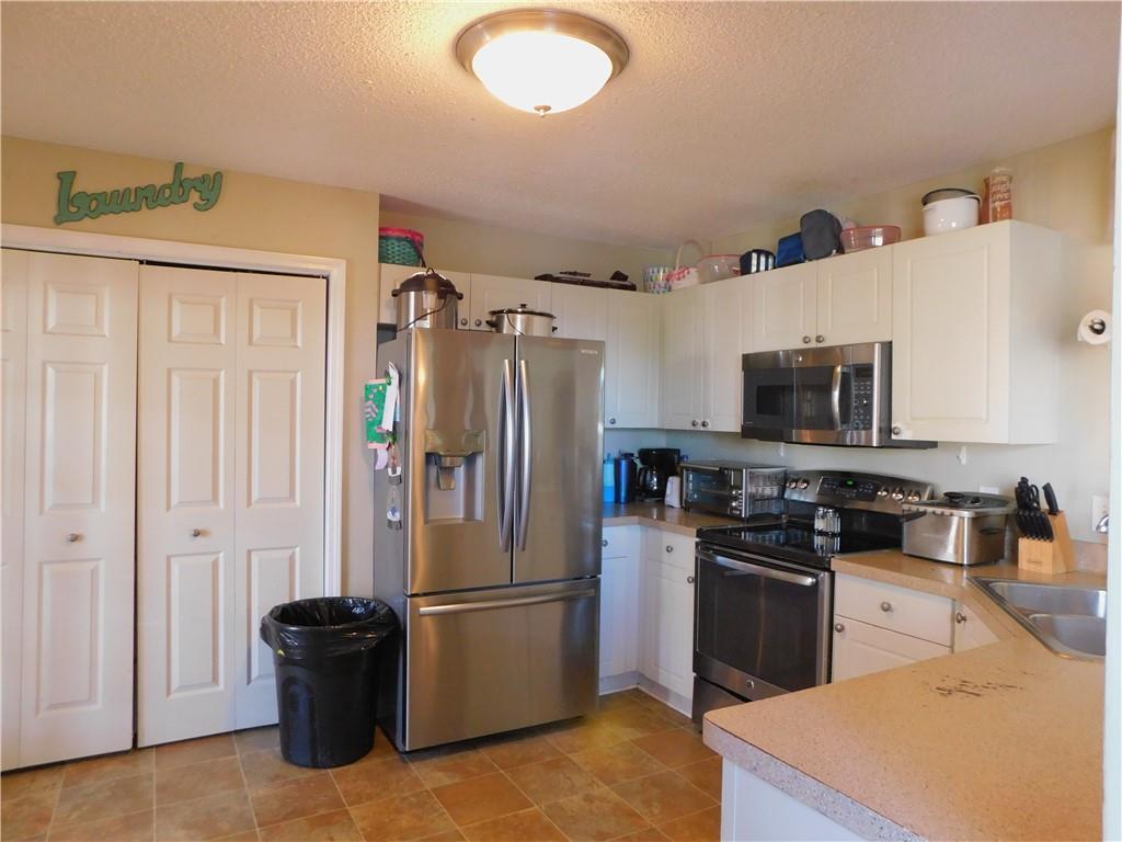 419 Rail Overlook Adairsville, GA 30103 - Photo 4 of 17 a kitchen with stainless steel appliances granite countertop a refrigerator stove and sink