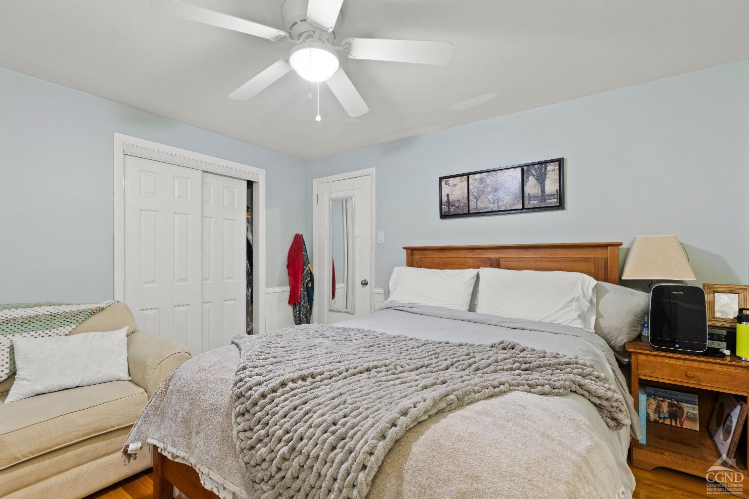 7 Red Apple Lane Catskill, NY 12414 - Photo 12 of 32 a bedroom with a large bed and a chandelier
