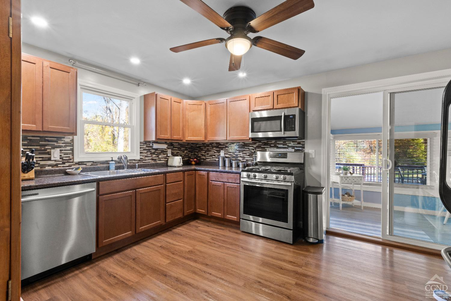 7 Red Apple Lane Catskill, NY 12414 - Photo 6 of 32 a kitchen with stainless steel appliances granite countertop a stove cabinets and wooden floor