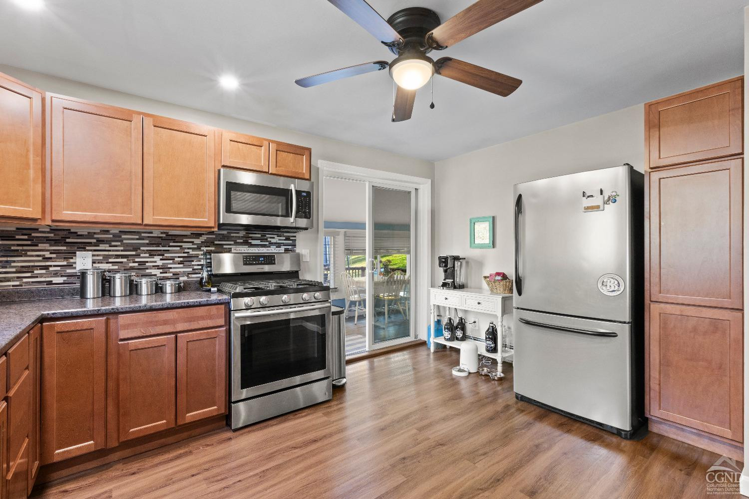 7 Red Apple Lane Catskill, NY 12414 - Photo 8 of 32 a kitchen with stainless steel appliances a refrigerator stove and wooden floor