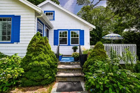 a front view of a house with a garden