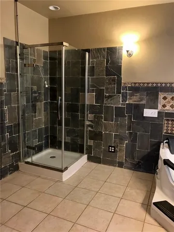 a bathroom with a shower and a sink