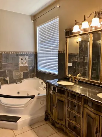 a bathroom with a tub and sink