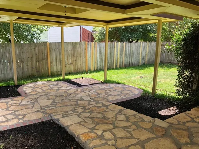 a backyard of a house with a yard and outdoor seating