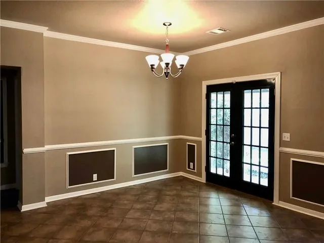 a view of an empty room with a fireplace and a window
