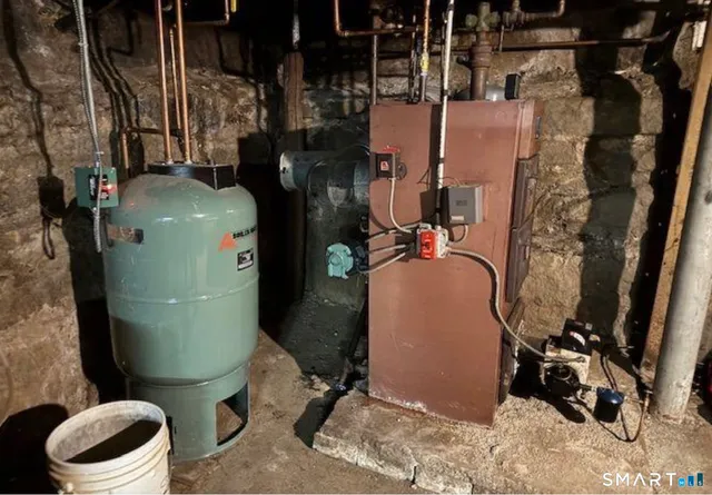 a room with water heater and a wooden door