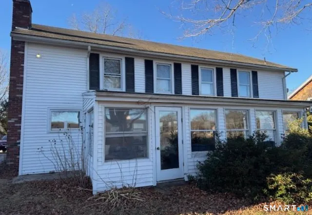 a view of a brick house with plants