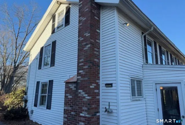 a view of a house with brick walls