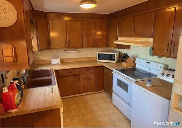 a kitchen with a sink stove and cabinets