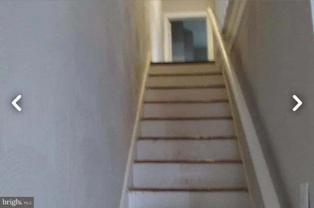 a view of staircase with white walls