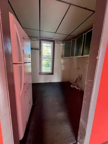 a view of walk in closet with wooden floor and a window