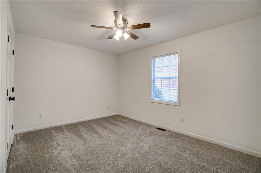 701 Longview Street Canton, GA 30114 - Photo 11 of 18 an empty room with a window and a fan