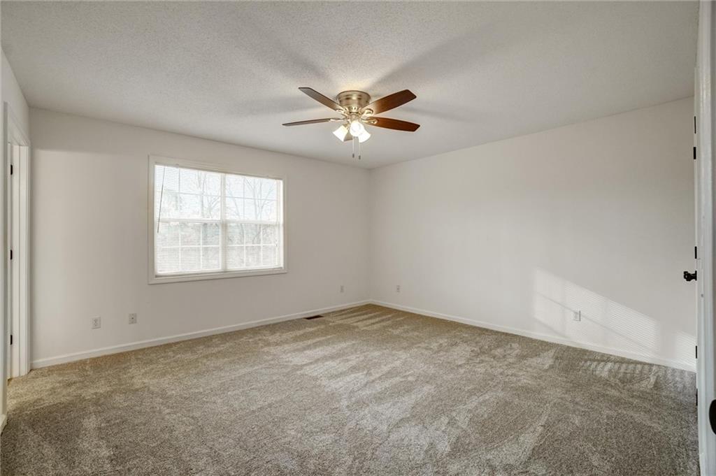701 Longview Street Canton, GA 30114 - Photo 13 of 18 an empty room with a window and a fan