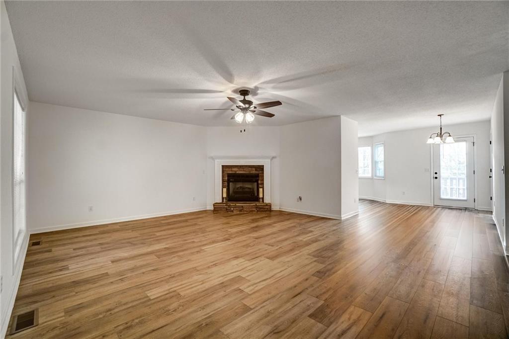 701 Longview Street Canton, GA 30114 - Photo 5 of 18 a view of an empty room with wooden floor and a fireplace