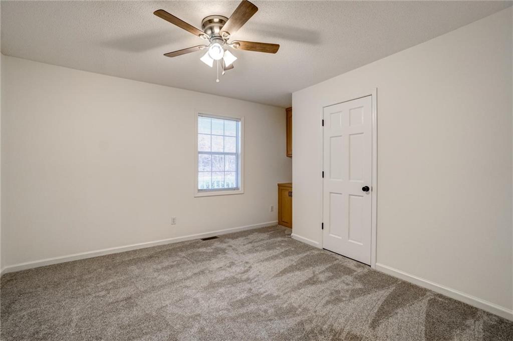 701 Longview Street Canton, GA 30114 - Photo 9 of 18 an empty room with windows and fan