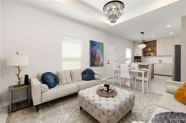a living room with furniture and a chandelier