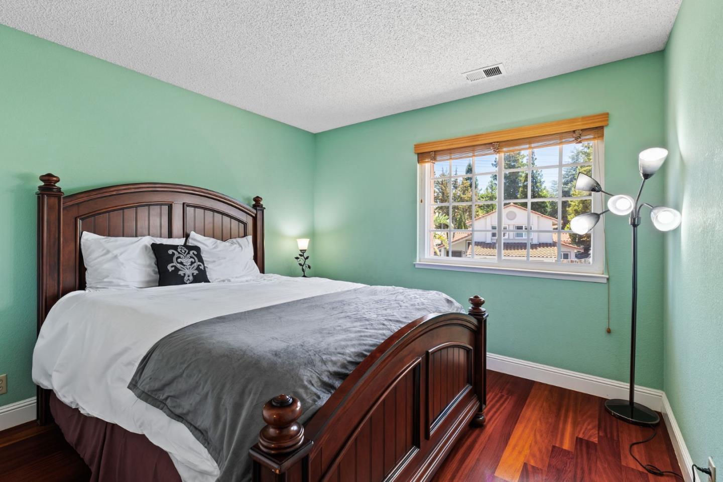 43643 Skye Road Fremont, CA 94539 - Photo 13 of 16 a bedroom with a bed and wooden floor