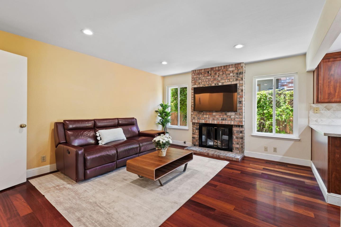 43643 Skye Road Fremont, CA 94539 - Photo 8 of 16 a living room with fireplace furniture and a flat screen tv