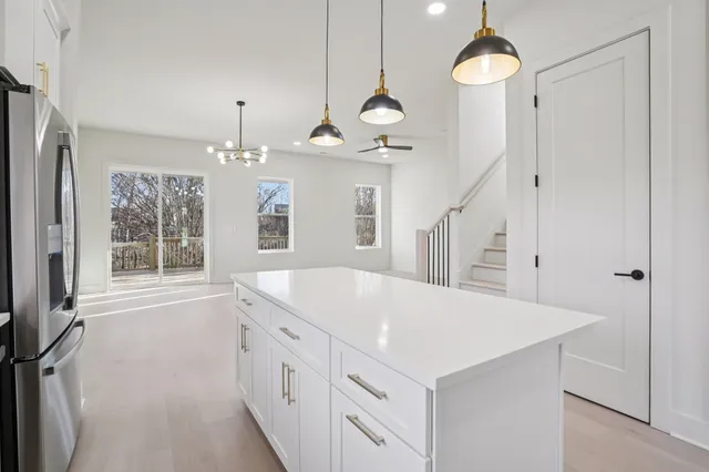 a very nice looking room with a large window and chandelier