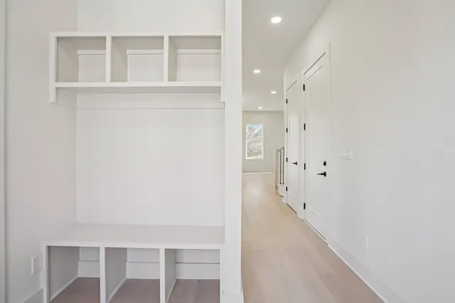 a view of a hallway with wooden floor and entryway