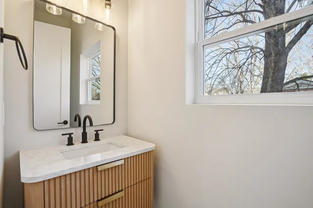 a bathroom with a sink and a mirror