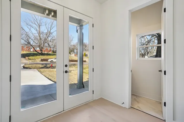 a bathroom with a glass shower door and a window