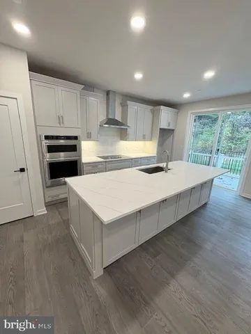 a kitchen with a stove a sink and a refrigerator