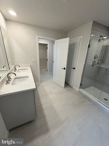 a bathroom with a sink a mirror and shower