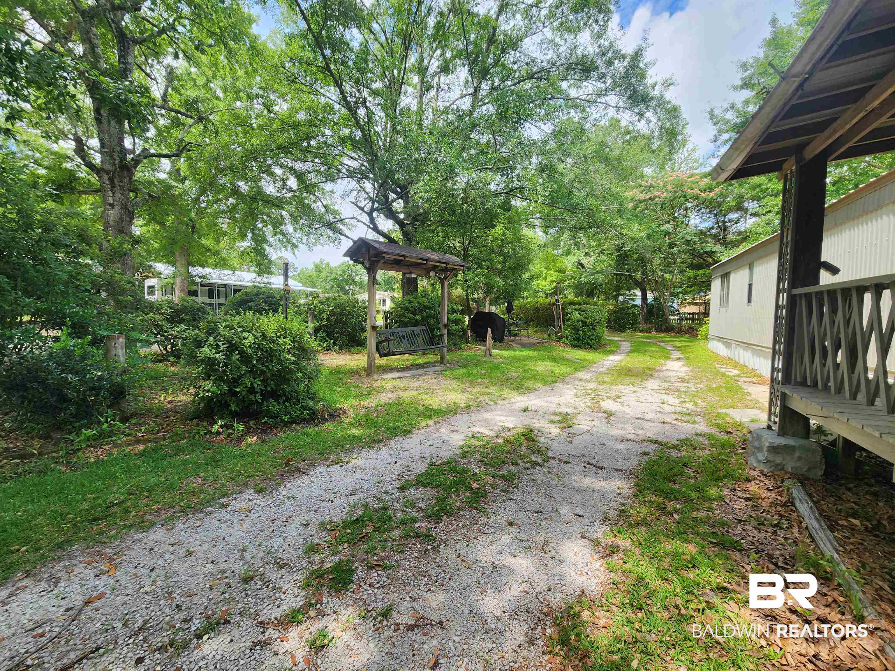 23051 Fritz Lane Foley, AL 36535 - Photo 7 of 26 Gravel drive with mature trees and established plantings