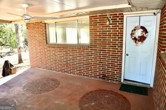 a view of a door with wooden walls and a window