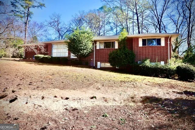 a front view of a house with a yard covered with snow
