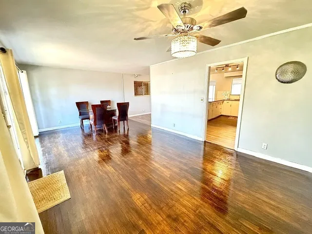 a view of a dining room with furniture and a chandelier fan