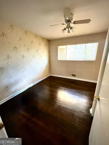 a view of room with window and a ceiling fan