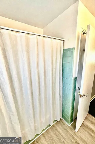 a view of a bathroom with a shower and a sink