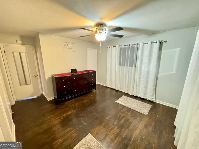 a view of room with window and a ceiling fan