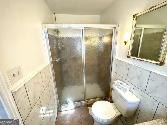 a white toilet sitting next to a bathroom sink