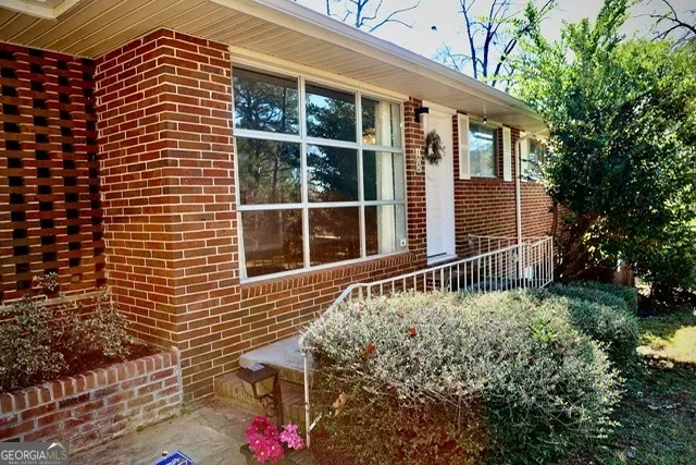 a front view of a house with a garden