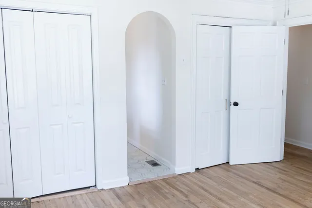 a view of a room with wooden floor
