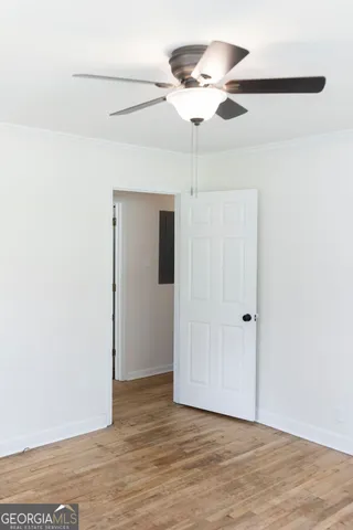a view of a hallway with wooden floor