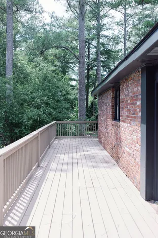 a view of a backyard with barn and large trees