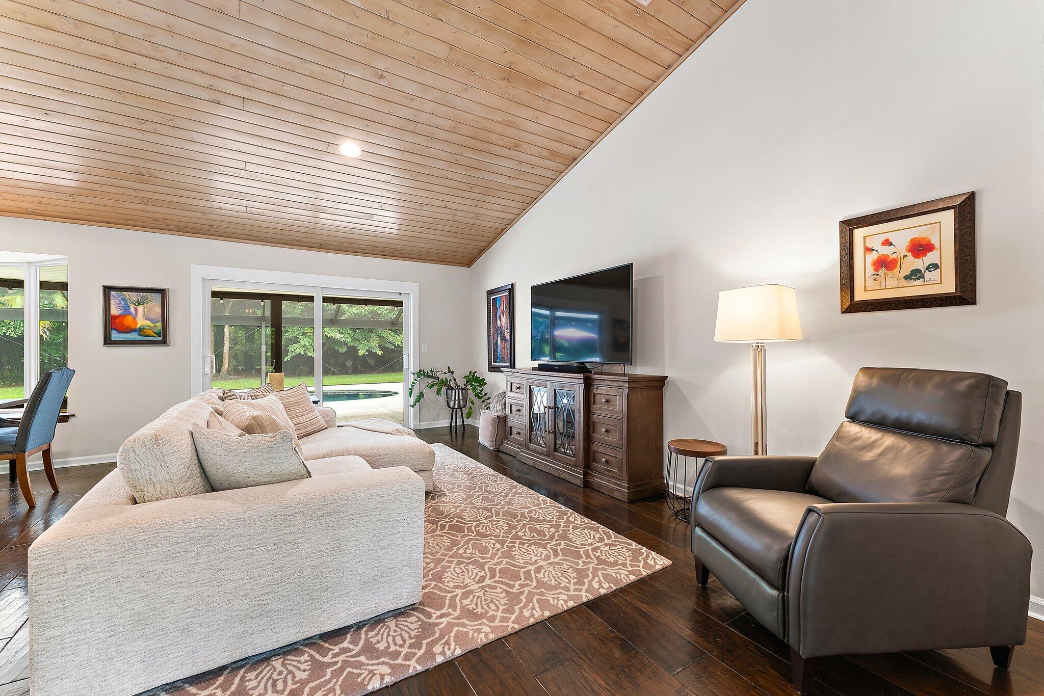 19546 Red Gum Trail Jupiter, FL 33458 - Photo 12 of 42 a living room with furniture and a flat screen tv