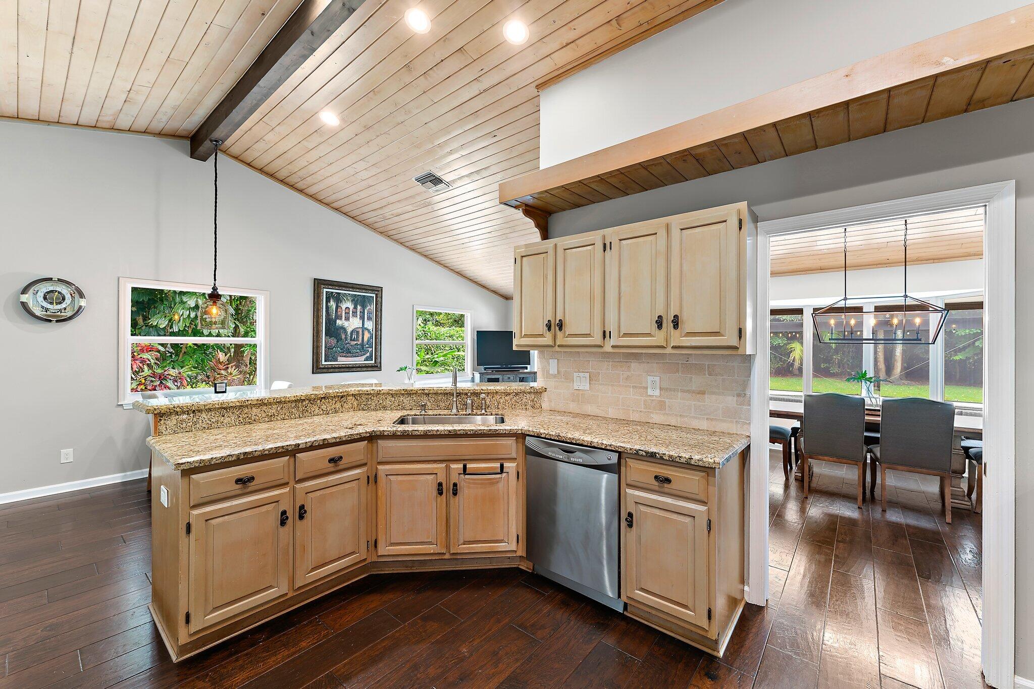 19546 Red Gum Trail Jupiter, FL 33458 - Photo 15 of 42 a kitchen with a sink window and cabinets