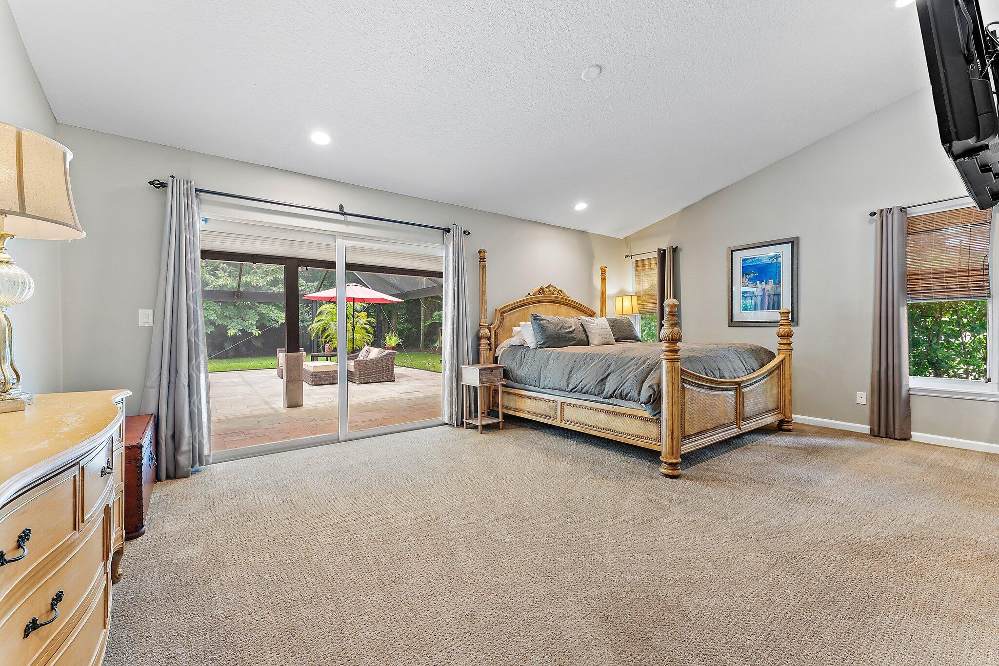19546 Red Gum Trail Jupiter, FL 33458 - Photo 21 of 42 a spacious bedroom with a bed and a large window