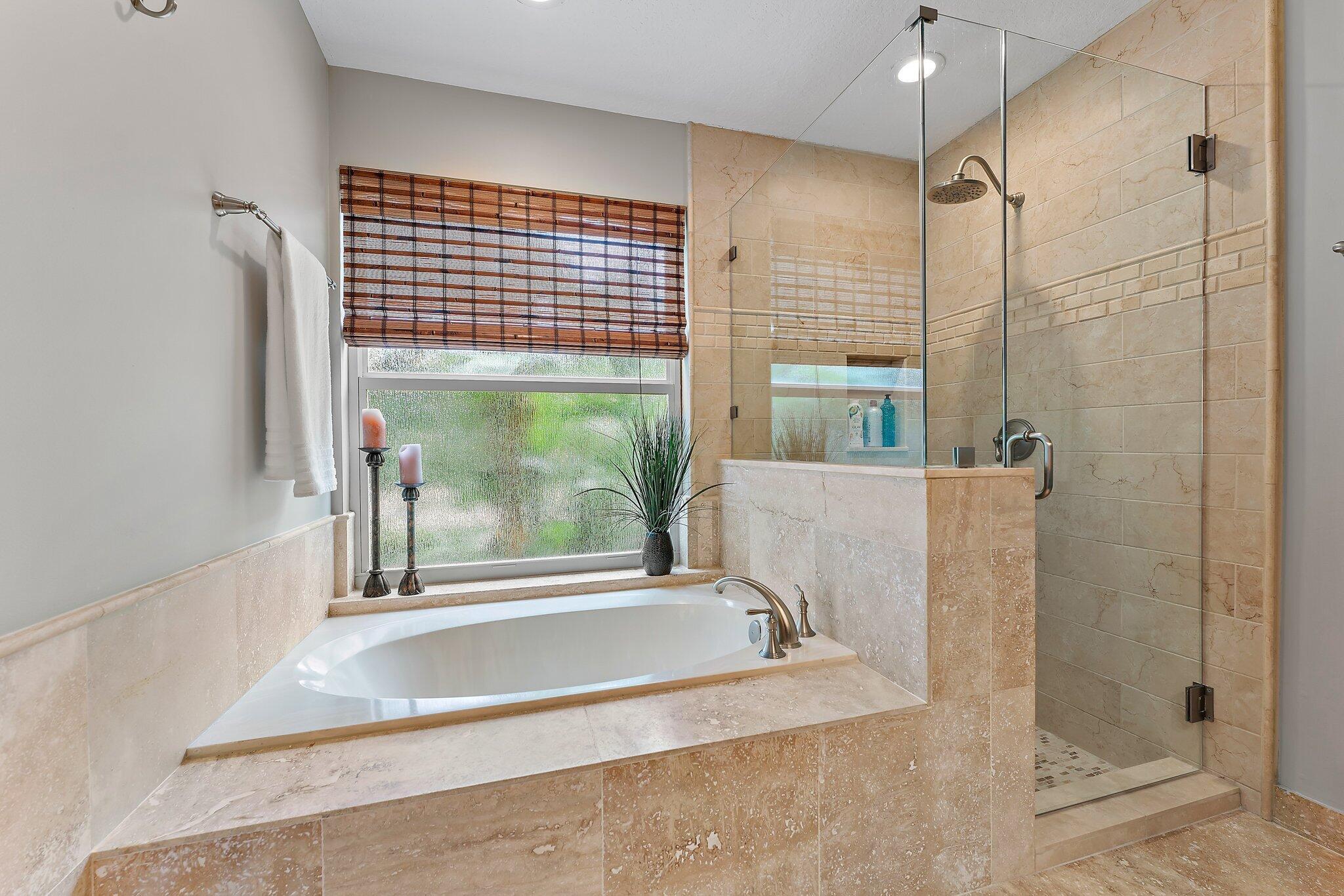 19546 Red Gum Trail Jupiter, FL 33458 - Photo 24 of 42 a bathroom with a bathtub and shower