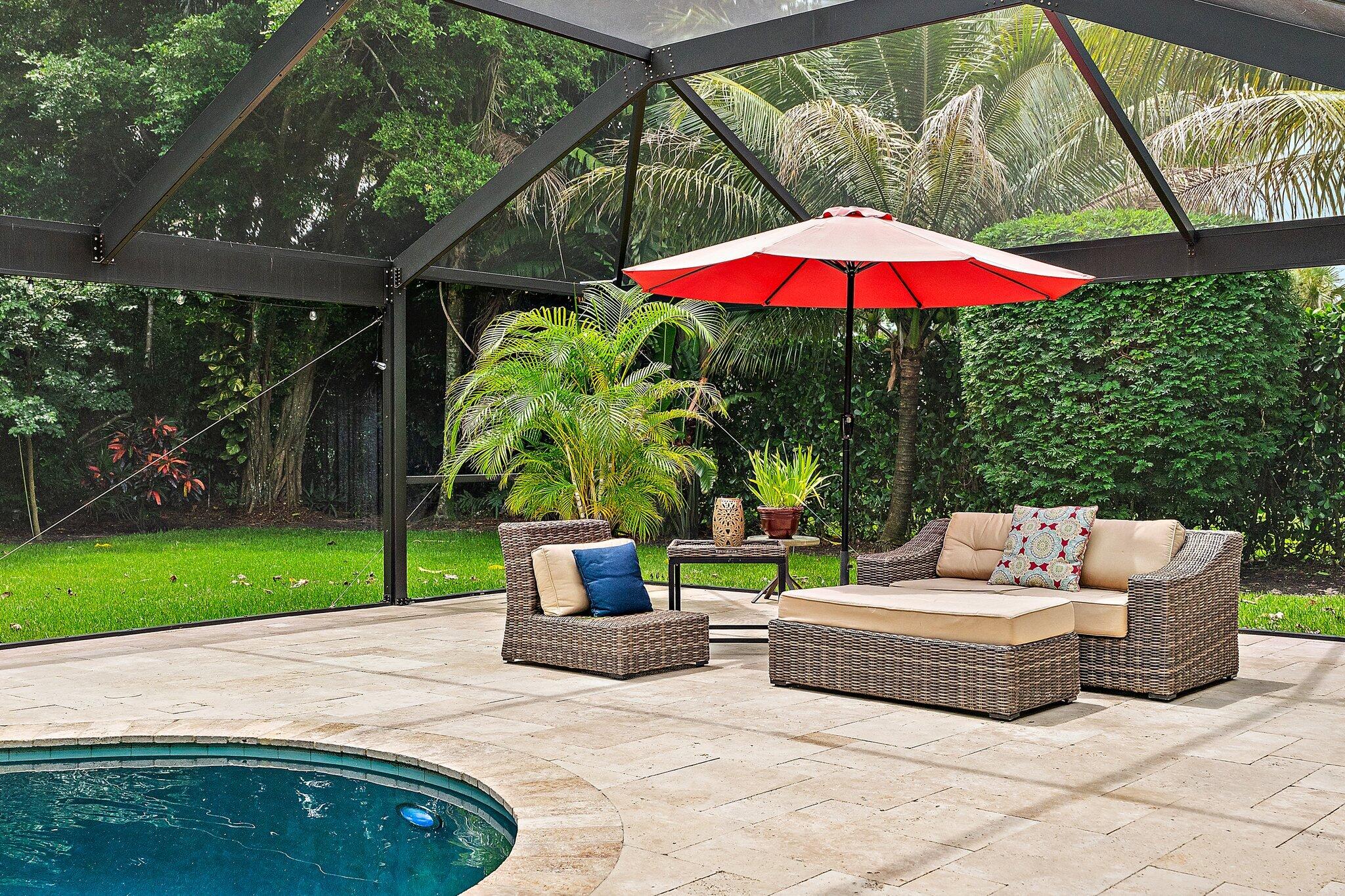 19546 Red Gum Trail Jupiter, FL 33458 - Photo 33 of 42 a view of backyard with swimming pool table and chairs